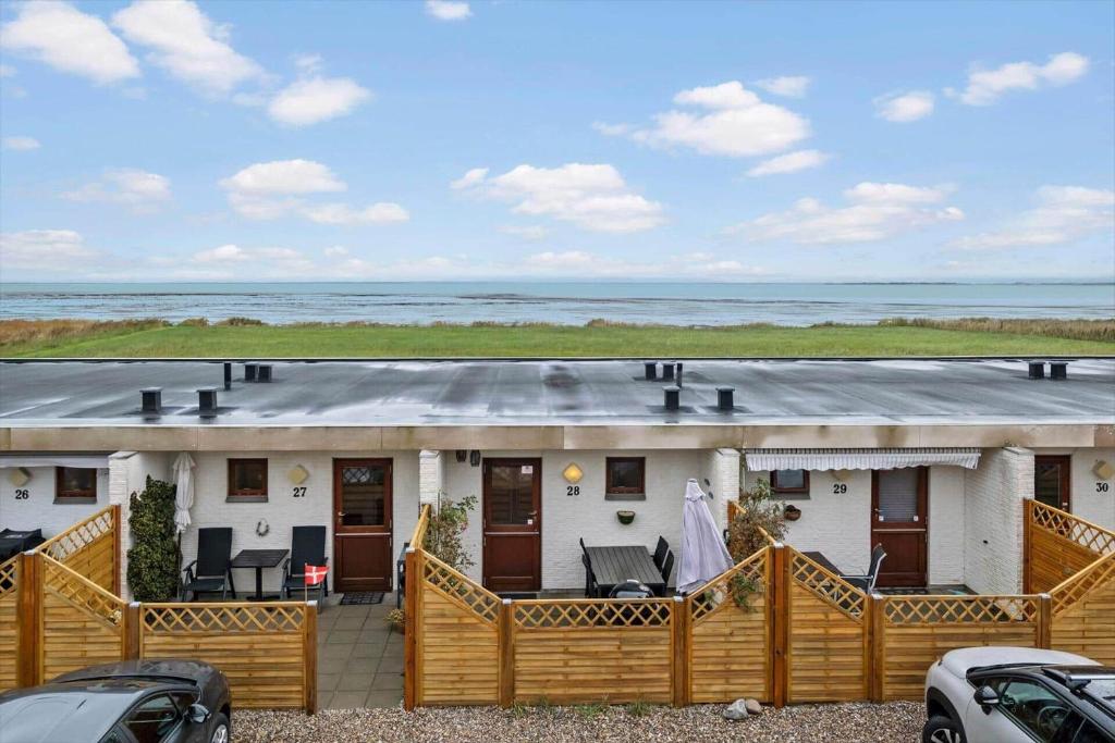 a large white house with a porch and the ocean at 0263-Romo-Lyngvejen-99-Ap-28 in Høm