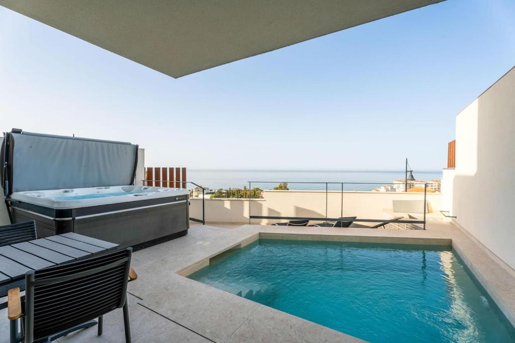 a swimming pool on a patio with a view of the ocean at House with Private Spa and Pool, with access to Sauna and Gym in Torrox Costa