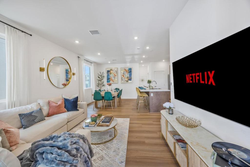 a living room with a couch and a tv at Luxury Resort Pool Spa Arcade Movie Gym in Mission Viejo