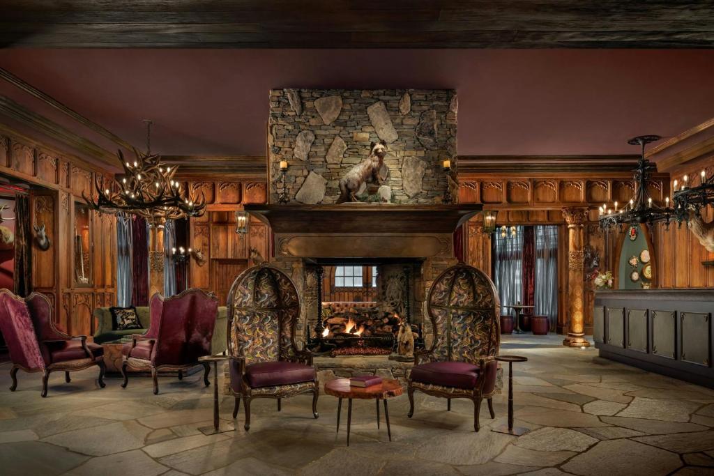 a large living room with a fireplace and chairs at Grand Bohemian Lodge Asheville, Autograph Collection in Asheville