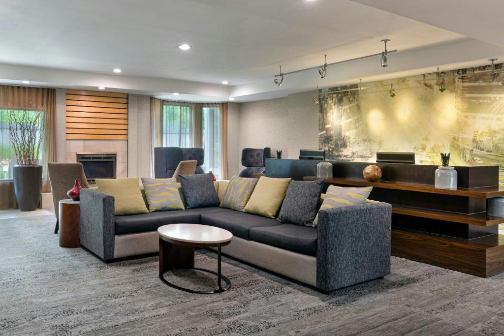 a living room with a couch and a table at Courtyard St. Louis Airport/Earth City in Bridgeton