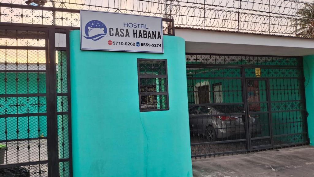 a blue building with a sign on it at Hostal Casa Habana in Managua