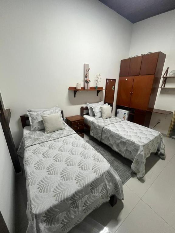 a room with two beds in a room at Casa da Ceiça in Belém