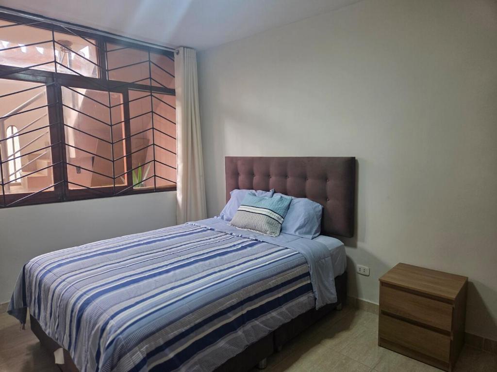 ein Schlafzimmer mit einem großen Bett mit Fenster in der Unterkunft Casa de La Reina in Chiclayo