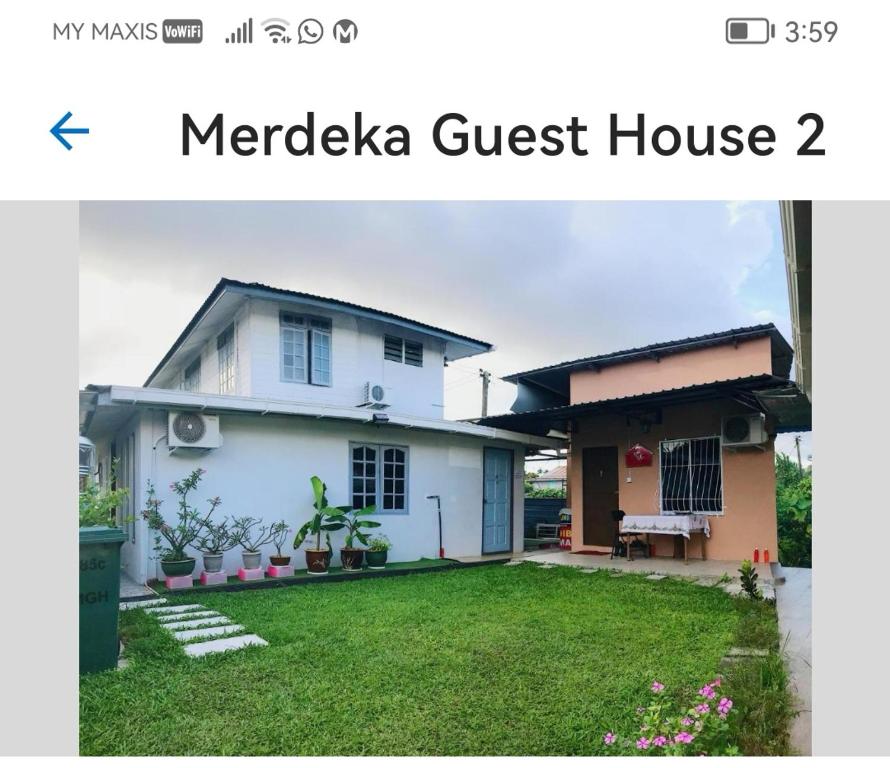 a house with a yard in front of it at Merdeka Guest House 2 in Kuching
