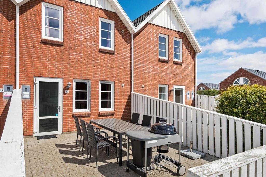 a patio with a table and chairs and a grill at 0440-Romo-Vestergade-227-Ap-17 in Sønderby