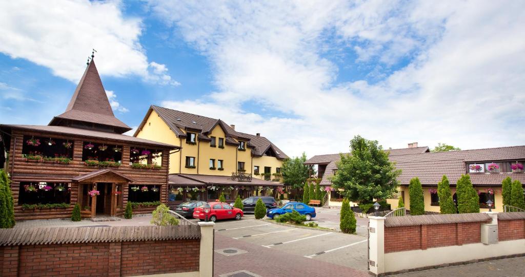 a building with a turret next to a parking lot at Pension Tempo in Târgu-Mureş