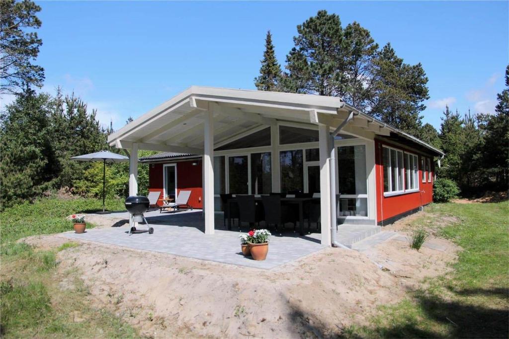 a pavilion with a grill in front of a house at 0362-Romo-Skovskaden-17 in Mølby