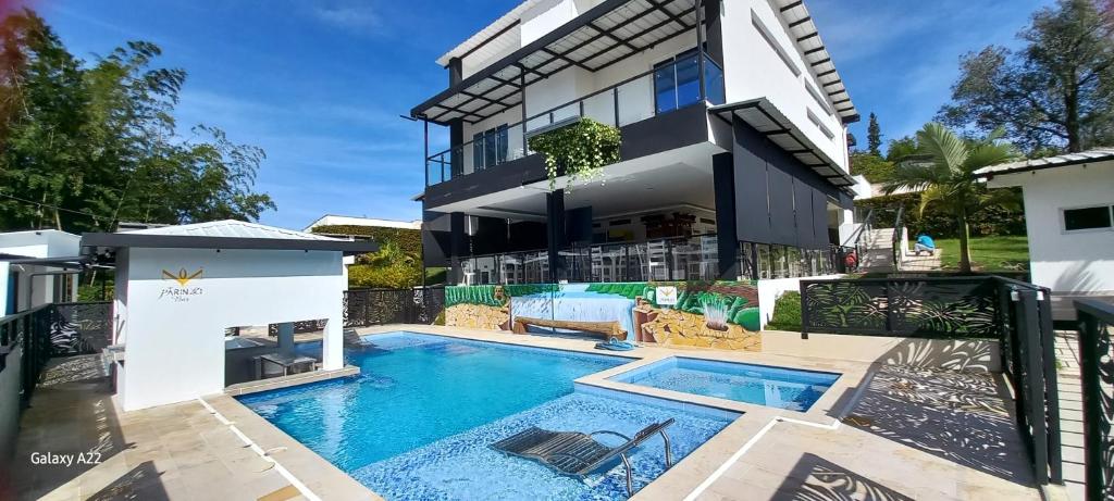 an image of a house with a swimming pool at Hotel y Cabañas Parinzzi in Guatapé