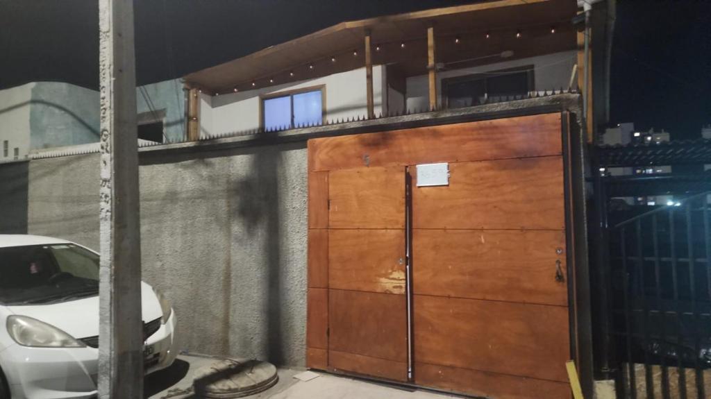 a pair of wooden doors on a building at casa para empresa o vacaciones in Iquique