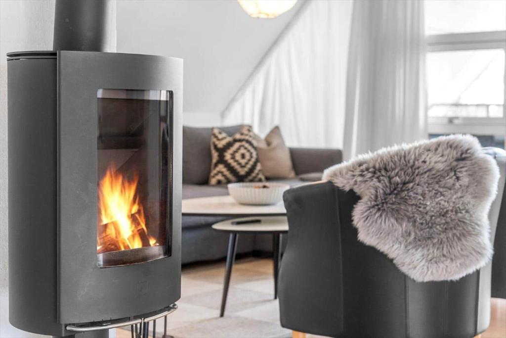 a living room with a fireplace and a couch at BV326-Blavand-Blavandvej-4-2 in Blåvand