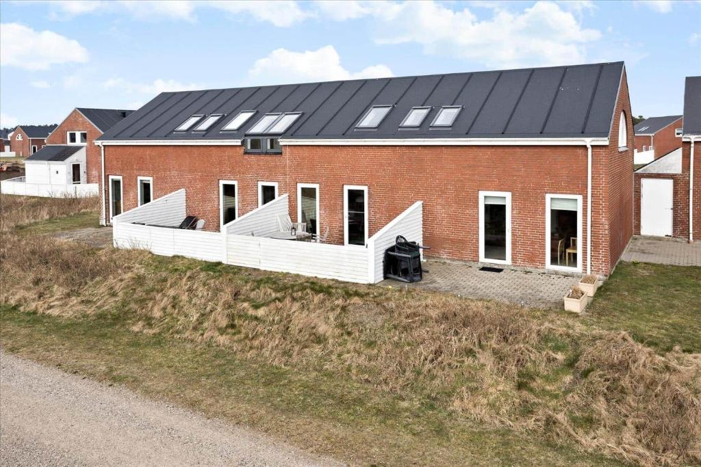 a red brick house with solar panels on it at 0366-Romo-Vestergade-153-B-Ap-126 in Sønderby