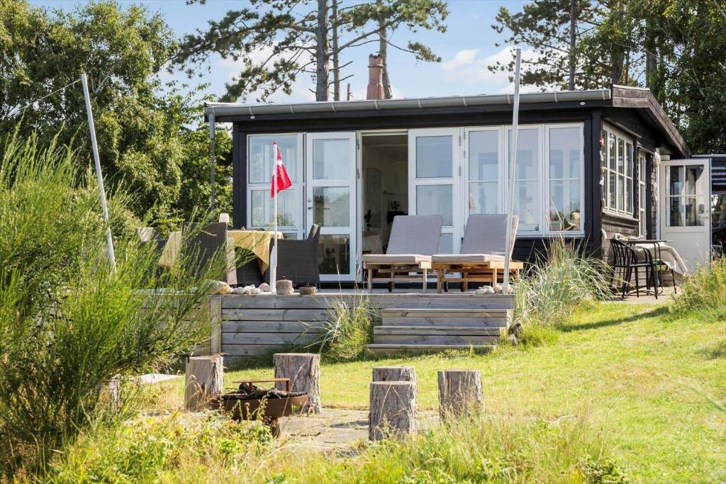 a tiny house with a flag on the front of it at 8224-Knebel-Capellavej-7 in Knebel