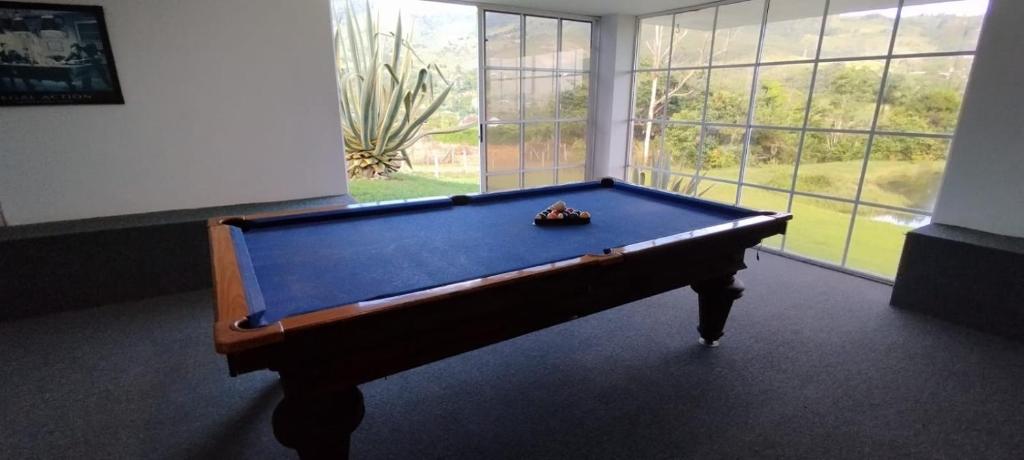 a pool table in front of a large window at Casa Campestre del Lago in Papagalleros