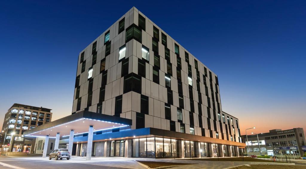 a tall black building with a parking lot at Distinction Invercargill Hotel in Invercargill