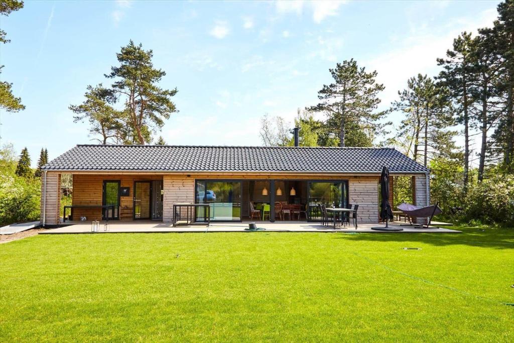 a small house with a large lawn in front of it at 11182-1-Nykobing-Sj-Thorsvej-34 in Nykøbing Sjælland