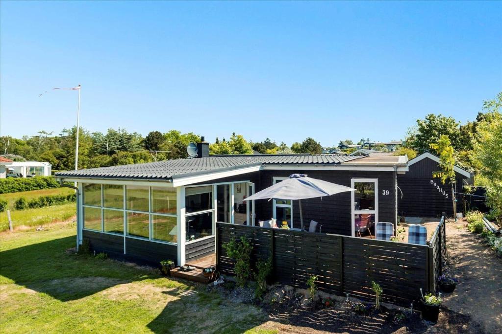 a small black house with a large window at 8002-Knebel-Vestre-Strandvej-39 in Knebel