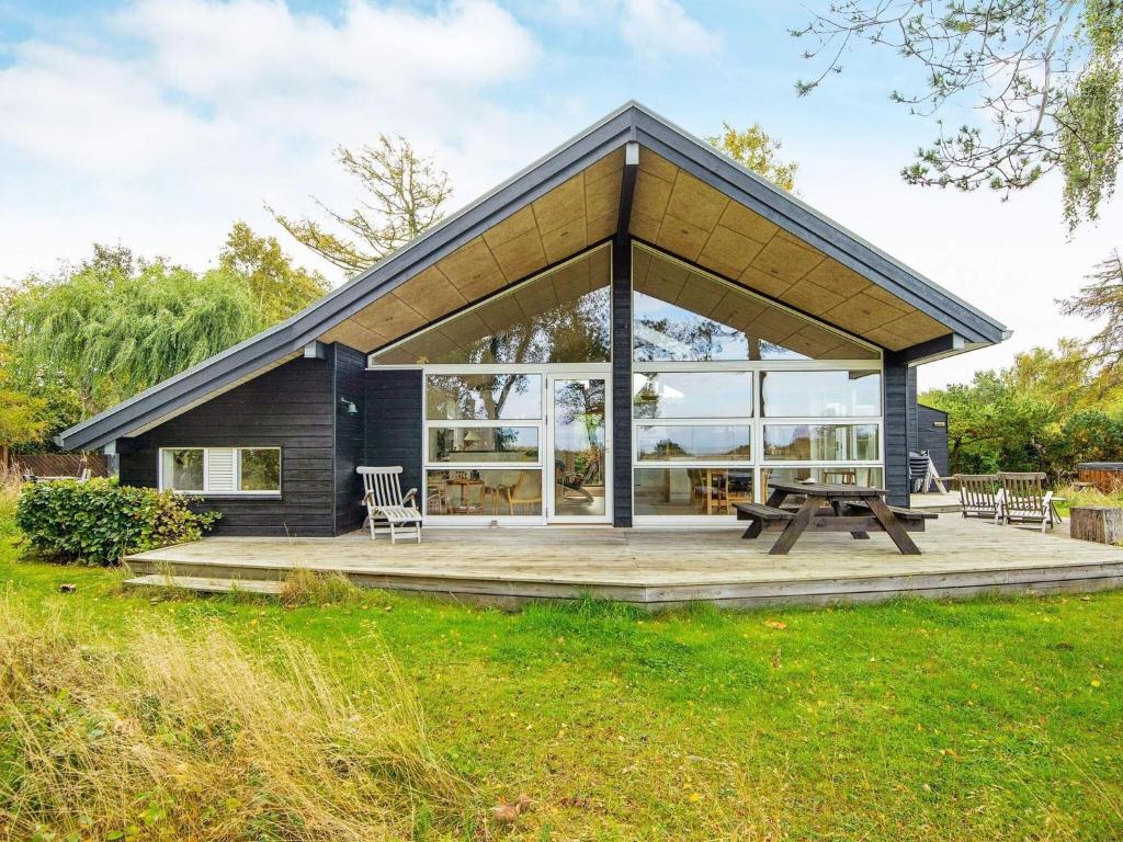 a house with a picnic table in front of it at 6 person holiday home in Glesborg-By Traum in Bønnerup