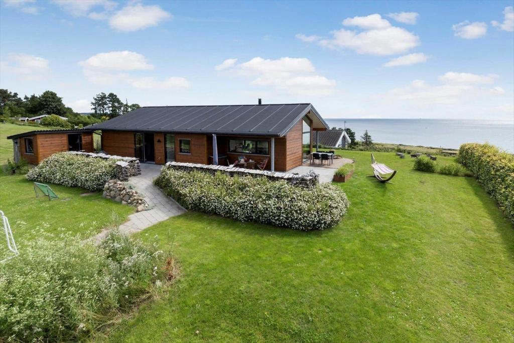 a small wooden house with a view of the ocean at 84213-Ebeltoft-Lokevej-8 in Ebeltoft