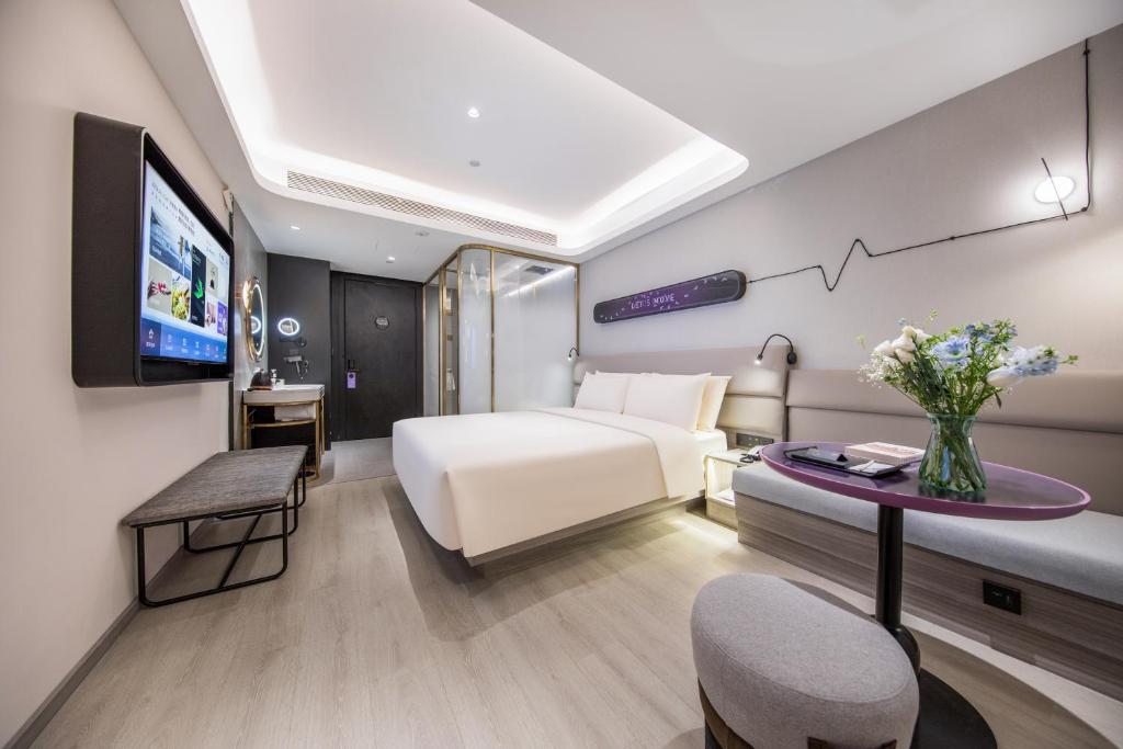 a hotel room with a bed and a tv at Atour X Hotel, Dongguan Street, Daming Lake,Jinan in Jinan