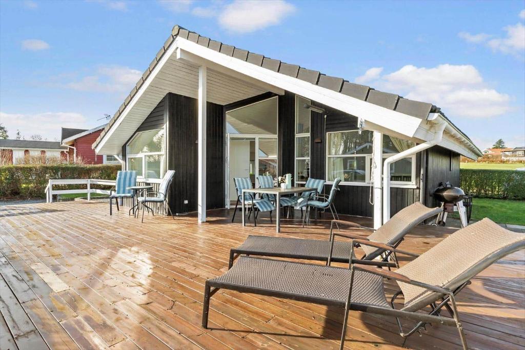 a pavilion with chairs and a table on a deck at 8106-Ronde-Lindeparken-10 in Rønde