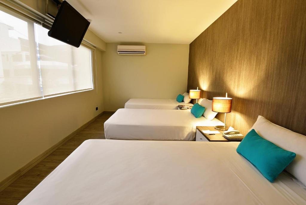Llit o llits en una habitació de Mariel Hotel Boutique