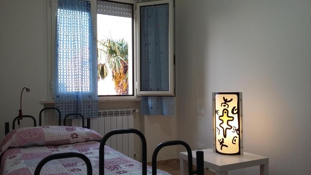 Schlafzimmer mit einem Bett, einem Tisch und einem Fenster in der Unterkunft Casa Vacanze Le Due Palme in Miglianico