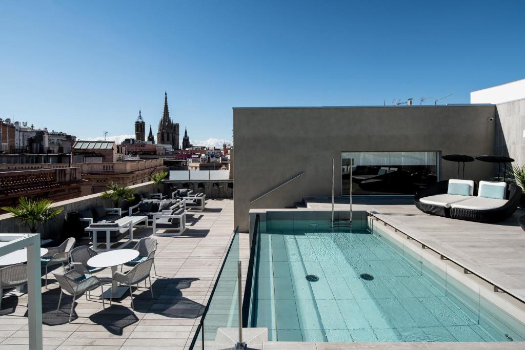 a swimming pool on the roof of a building at Catalonia Magdalenes in Barcelona