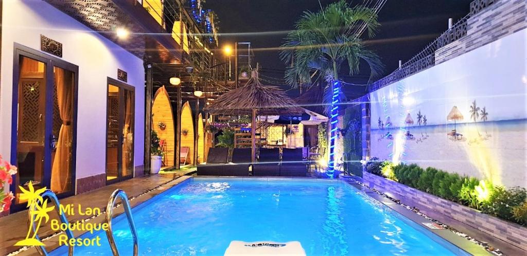 a swimming pool with a gazebo next to a building at MILAN Boutique Garden in Vung Tau