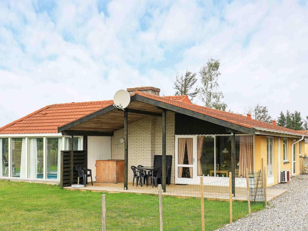 a small house with a porch and a patio at 6 person holiday home in Ulfborg-By Traum in Sønder Nissum