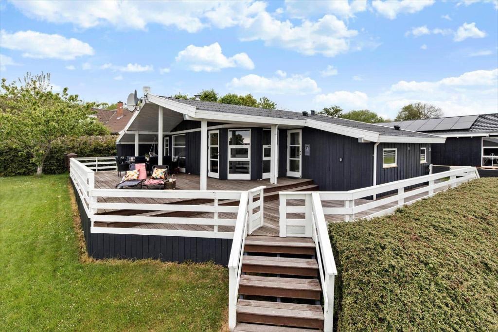 a house with a large porch and a deck at 8124-Ronde-Rytterparken-33 in Rønde