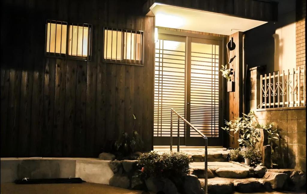 a front door of a house at night at 夏様楽善 Historic Kyoto Machiya,Experience Japanese Lifestyle Comfortably in Kyoto