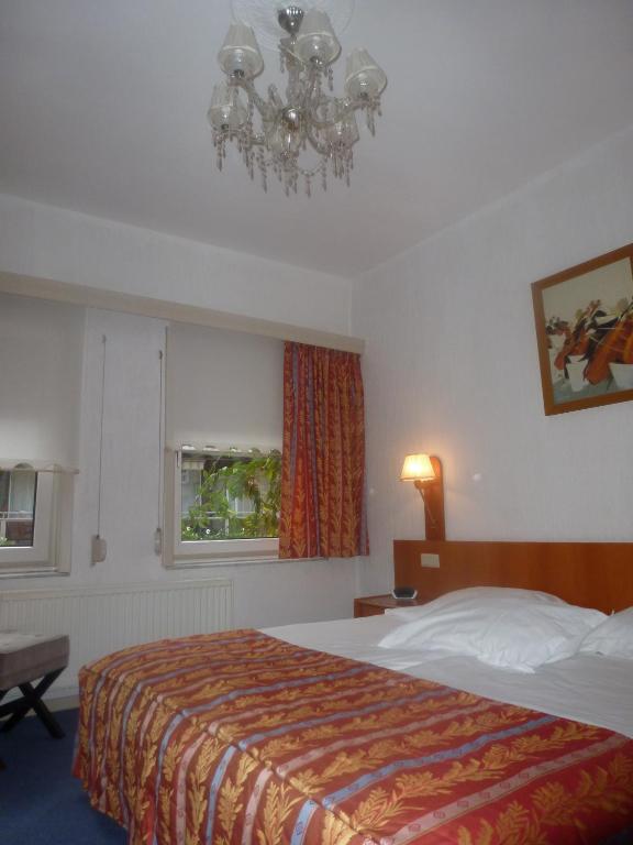 Postel nebo postele na pokoji v ubytování Hotel 'T Hert