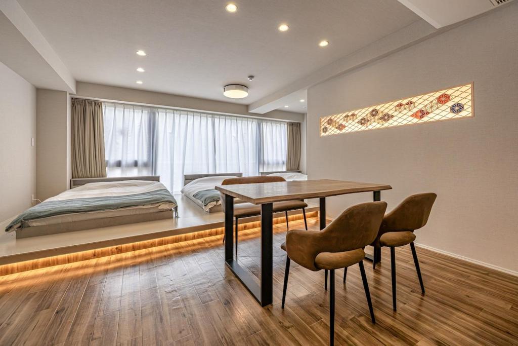 a bedroom with a bed and a table and chairs at 365Ueno in Tokyo