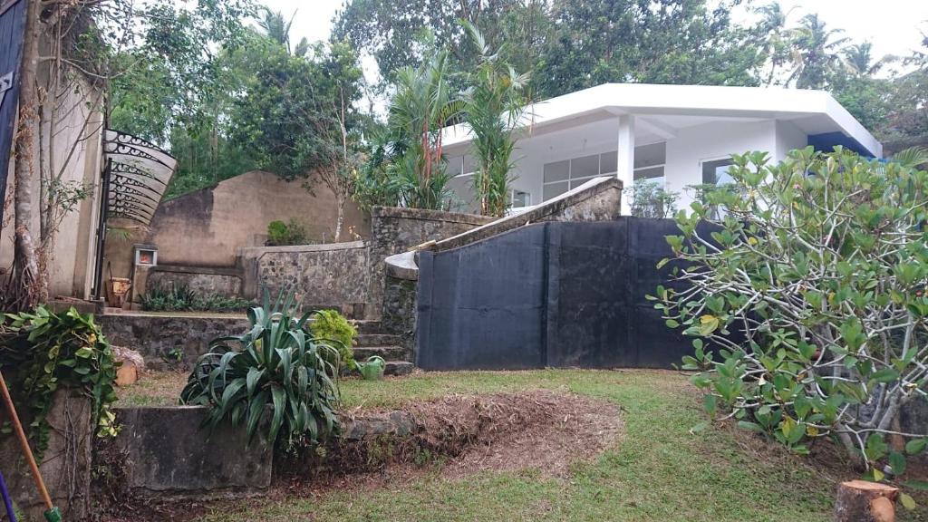 a house with a fence in front of a yard at My Dream Home Sri Lanka in Weligama