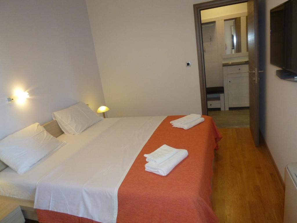 Postel nebo postele na pokoji v ubytování Apartments Jukic