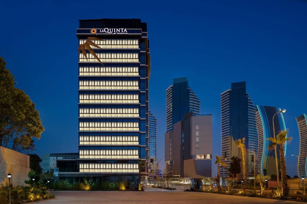 a tall building with a sign on it in a city at La Quinta By Wyndham Istanbul Kartal in Istanbul