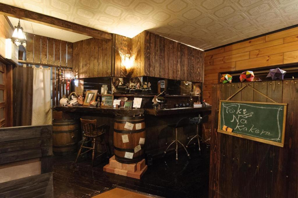 a bar in a restaurant with a sign on the wall at Secret Base Tokinokakera in Yufuin