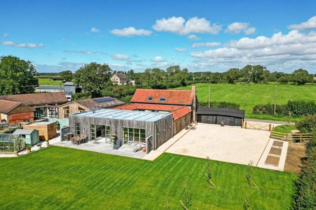 an aerial view of a house with a large backyard at The Old Dairy A Stunning Detached Rural Retreat in Crudwell