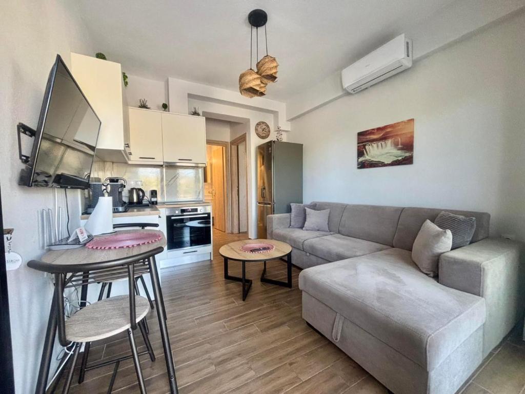 a living room with a couch and a table at Chloe Stay Complex by Horizon Homes in Orfánion