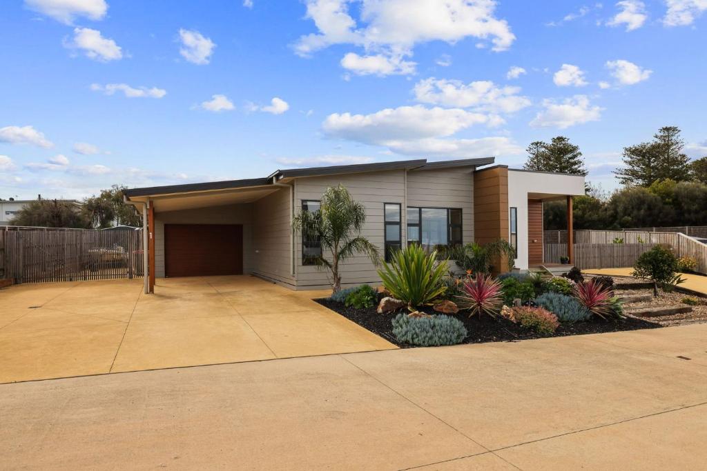 a house with a lot of plants in front of it at Woolamai Beachside Retreat in Cape Woolamai
