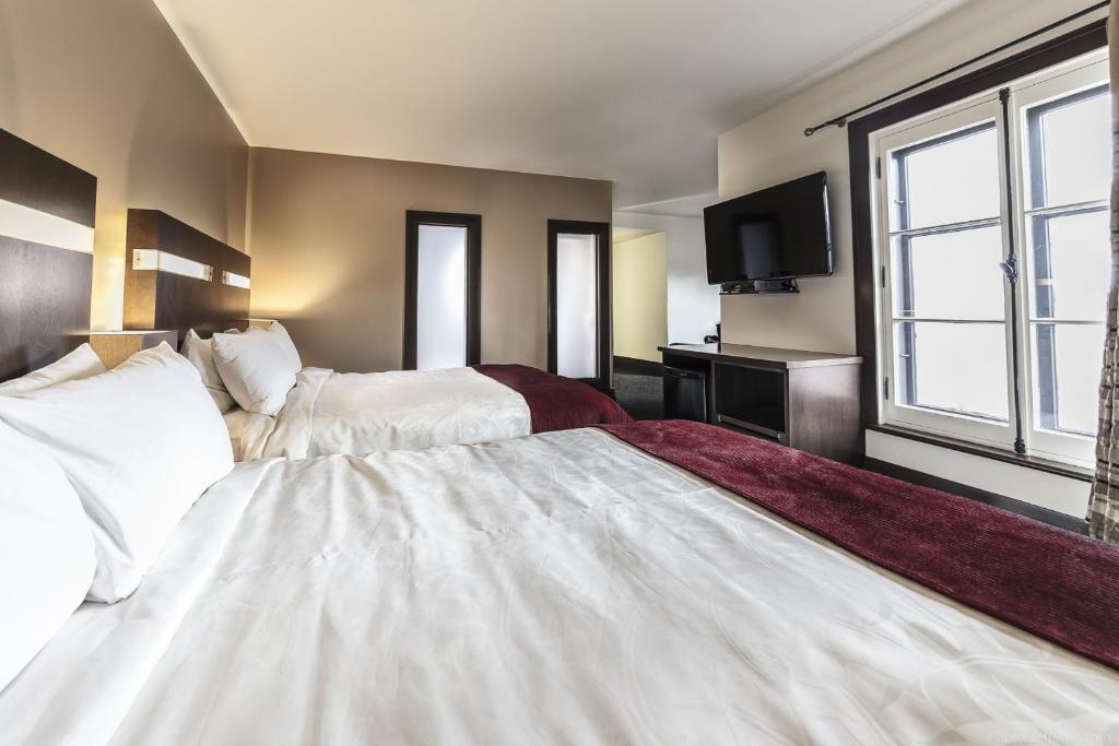 Postel nebo postele na pokoji v ubytování Hôtel Sainte-Anne