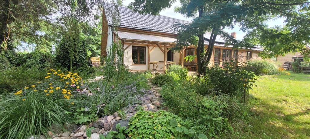 a small house with a garden in front of it at Esterka Village in Esterka