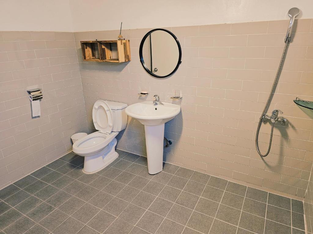 a bathroom with a toilet and a sink at Cozy Butter Stay Jeonju in Jeonju