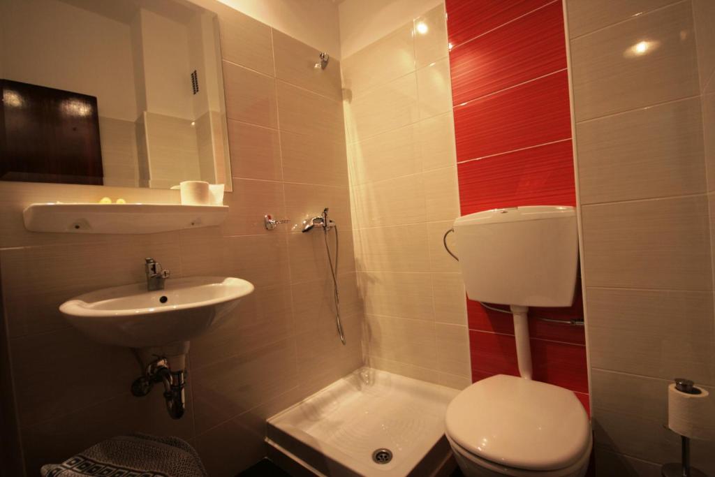 a small bathroom with a toilet and a sink at Vienna Hotel in Athens