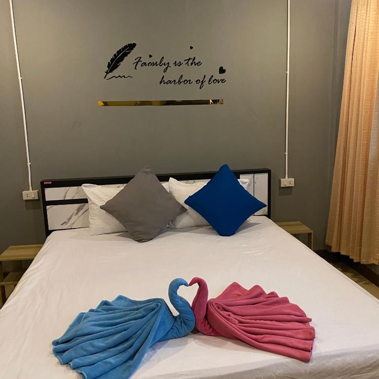 two towels are laying on a bed with at Saran Hotel krabi Thailand in Krabi