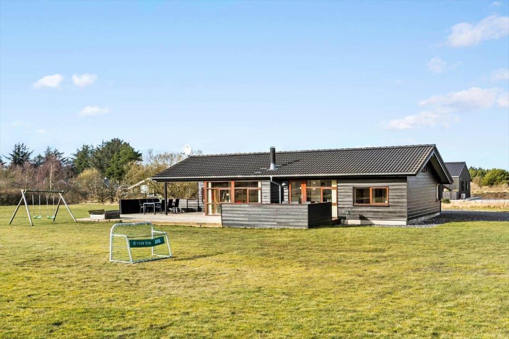 a house with a soccer ball in the yard at LK537-Lokken-Mievej-20 in Løkken