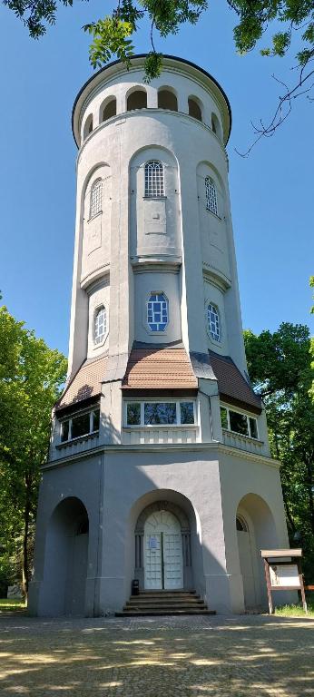 a tall building with a round tower on top at Taurasteinblick in Burgstaedt