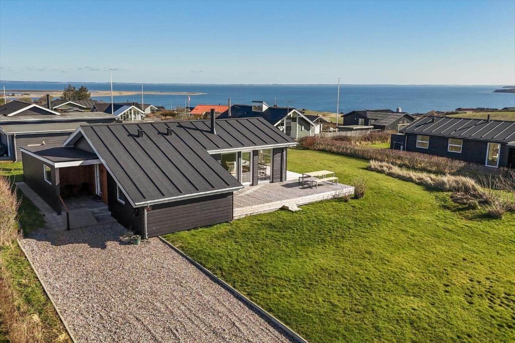 a small house with a roof on a grass field at G219-Lemvig-Skovstjernevej-19 in Lemvig
