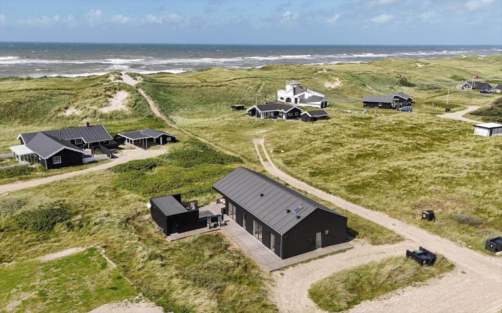 an aerial view of a group of cabins at the beach at 341-Harboore-Gloryvej-27 in Harboør